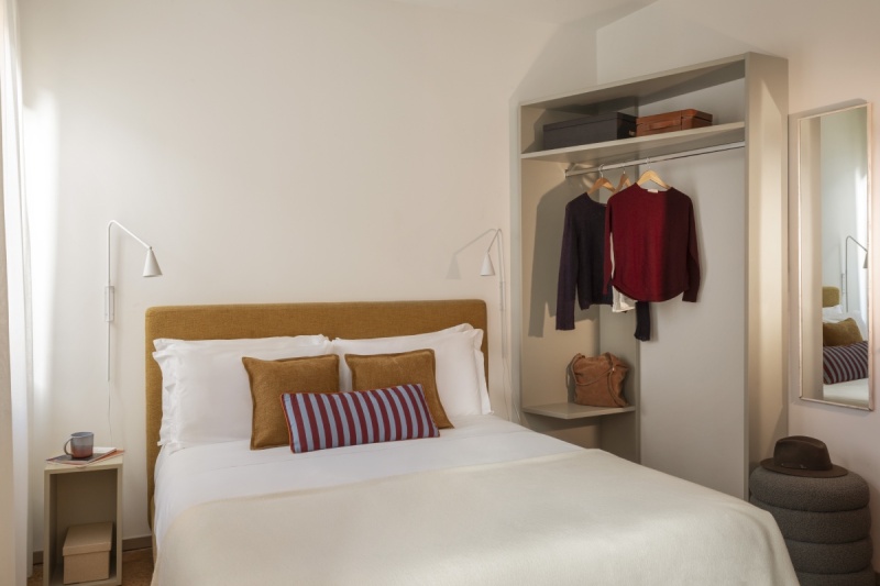 Venice Standard room with modern double bed, mustard headboard, and open minimalist wardrobe - Ca' La Stampa, BZAR hotels in Venice