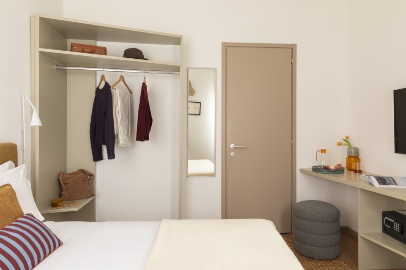 Desk and TV area in Standard room with contemporary design, grey ottoman, and coffee mug - Ca' La Stampa, BZAR hotels in Venice